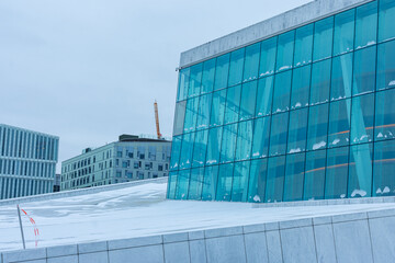 Detail of Opera house in Oslo during the midday in winter. Cloudy weather above opera house,...