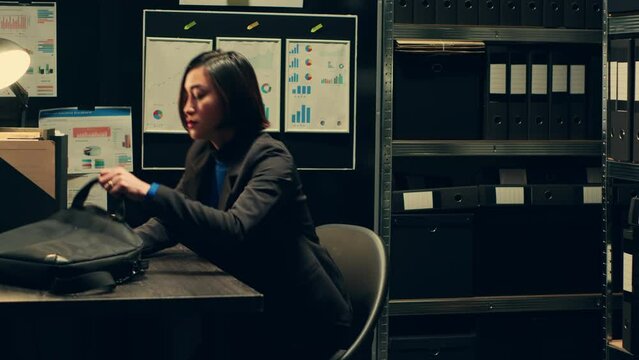 Private officer sitting at workstation to develop profiles of potential suspects based on archived data, using forensic techniques to examine evidence in the archive. Criminology expert. Camera A.