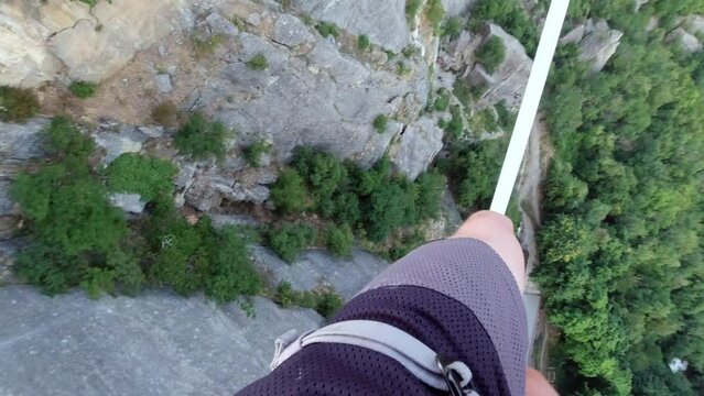 Concept of balance: The precipice at the base of the Bismantova stone seen from a tightrope walker on the slackline 200 meters above, Castelnovo n&egrave; Monti, Reggio Emilia, Italy