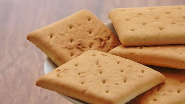 Gyration hardtack cookies on a plate on a wooden table background.