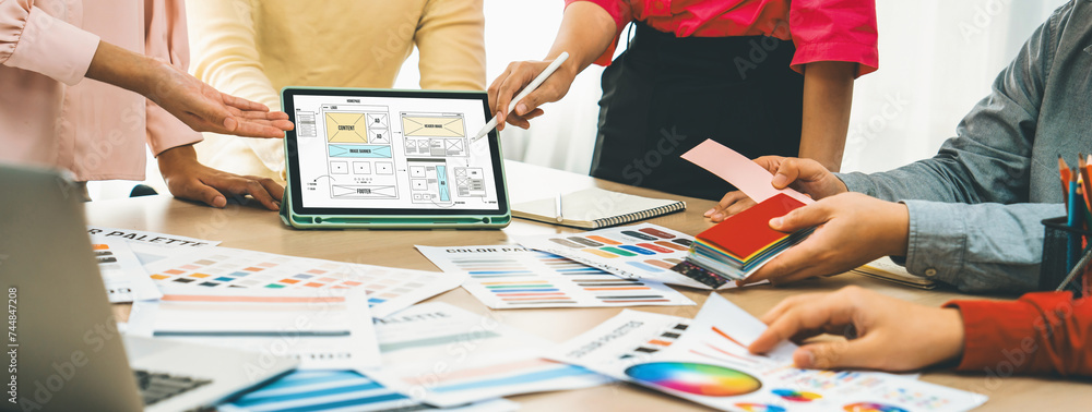 Poster cropped image of interior designer team discuss the material color while tablet displayed website wi