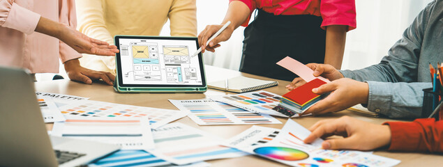 Cropped image of interior designer team discuss the material color while tablet displayed website...