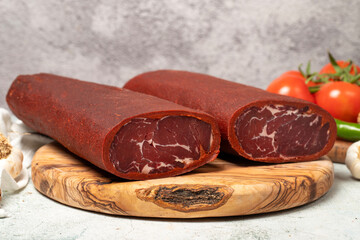 Turkish pastrami. Traditional Turkish cuisine flavors. Bacon on a cutting board. local name sivas pastirma