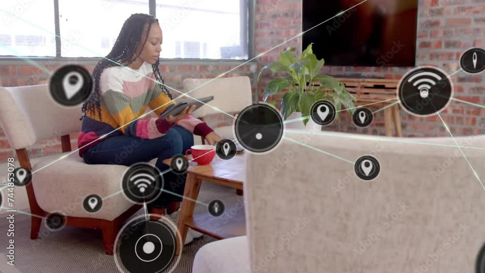 Wall mural Animation of network of connections with wifi icons over african american woman using tablet