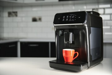 Modern coffee machine on table in kitchen