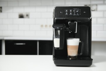 Modern coffee machine on table in kitchen