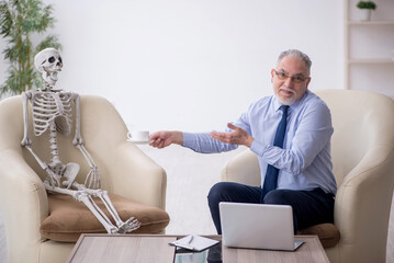 Old male psychologist meeting with skeleton
