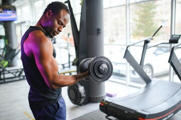 Fototapeta na wymiar African American man working out in the gym.