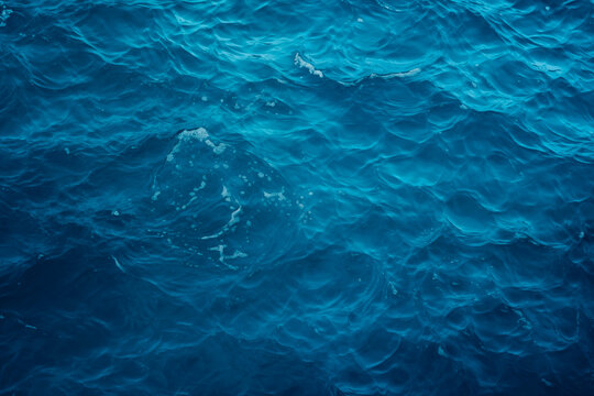 Calm blue ocean surface with gentle waves, depicting serenity and depth.