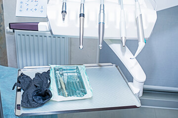dental bur machine with attachments, instruments and disposable gloves. Treatment and restoration of teeth