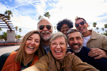 Group of multiracial middle-aged people cheerful and smiling taking a selfie together on their trip...