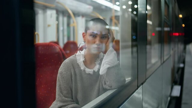 Girl waiting train trip looking through window close up. Woman sitting railway 