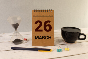 March 26th. Image of march 26 wooden color calendar on blue background. Spring day, empty space for...