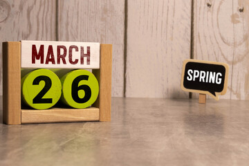March 26th. Image of march 26 wooden color calendar on blue background. Spring day, empty space for...