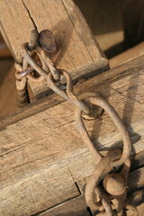 old fastening chain on old wooden frame