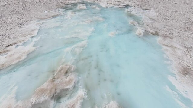 A pool of fluid among the snow, a geological phenomenon in the natural landscape