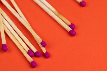 matches with a red pink substance for lighting on an orange background
