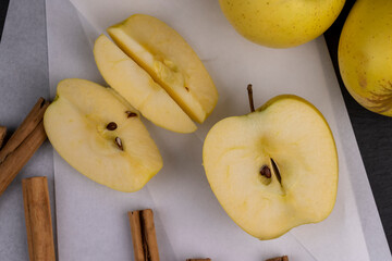 yellow ripe apple with cinnamon on the table