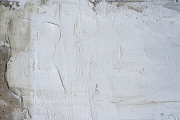 A gray cement wall with layers of carelessly laid render. Vector cement texture background