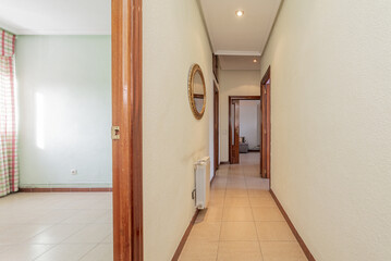 Corridors of an empty house with sapelly wood carpentry on doors, moldings and skirting boards