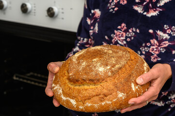 appetizing homemade whole grain bread in the hands of a woman 8