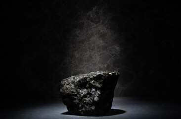 natural black stones for the podium on a dark background