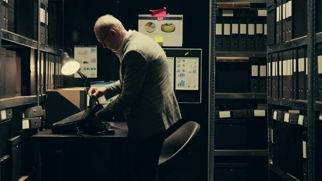 Senior investigator studying archive folders for case similarities, looking for incriminating evidence during legal inquiry. Law enforcement agent reading federal classified notes. Camera B.