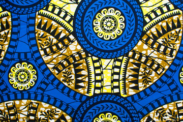 top view of blue and yellow ankara fabric, flatlay of nigerian wax cloth with designs, spread out blue and yellow ankara material