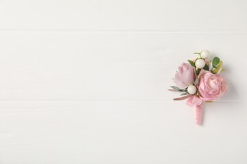 Beautiful boutonniere on white background, top view. Space for text - obrazy, fototapety, plakaty