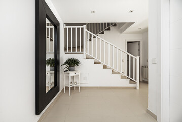 Several flights of stairs in a single-family home of various heights with white painted metal...