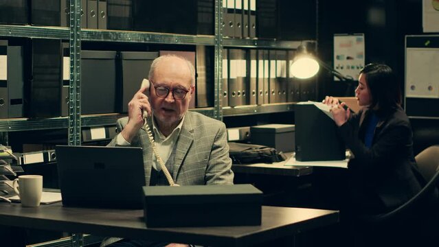 Private investigator requesting crucial information on landline phone call, reaching out to colleagues to find specific evidence relevant to crime case. Detective asks for assistance. Camera A.