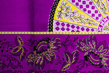 top view of purple ankara fabric, flatlay of nigerian wax cloth with designs, spread out purple...