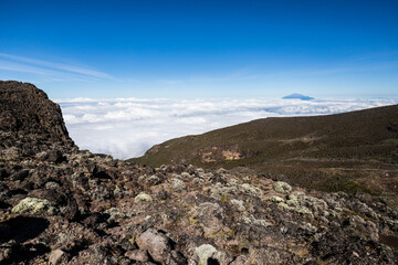 Elevated Majesty: Kilimanjaro’s Peak Overlooking Distant Mt. Meru