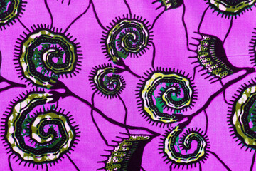 top view of purple ankara fabric, flatlay of nigerian wax cloth with designs, spread out purple...