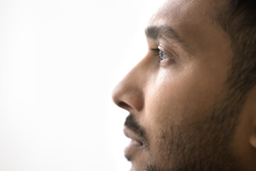 Close up profile photo of handsome serious Indian man on white gray studio background. Guy having...