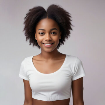 Smiling beautiful African girl with healthy white teeth. Girl smile and curly hair. Laughing cute Afro girl portrait in a studio
