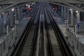 the atmosphere of the train tracks at the light rapid transit station along with signals as a guide