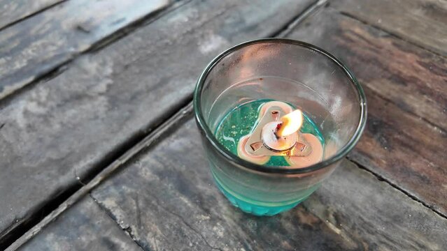 4k video footage of Oil lamps or kerosene lamp lantern with fire inside the glass on wooden table. Old traditional storm lamps. Liquid candle.