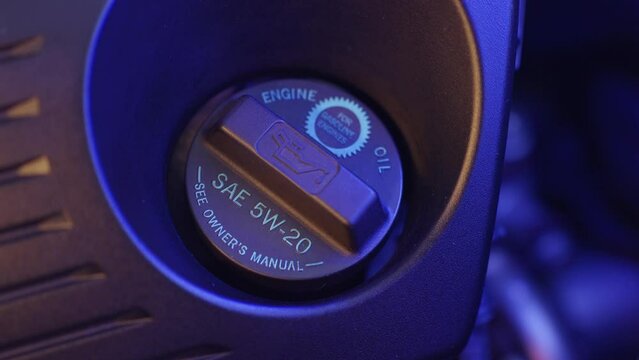Detailed View of a Vehicle's Oil Filler Cap Indicating Required Oil Type SAE 5W-20 for Engine Maintenance