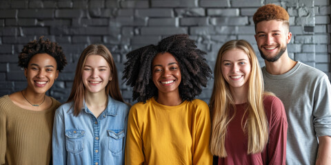 Smiling Multicultural Friends Together.
A diverse group of young adults smiling against a brick wall background.