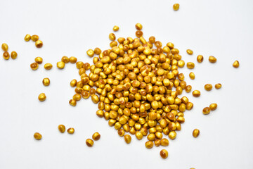 gold masterbatch granules on a white background, this polymer is a coloring agent for products in the plastics industry