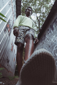 Urban Explorer: A Person Walking Between Graffiti-Covered Walls, Embodying the Spirit of the City