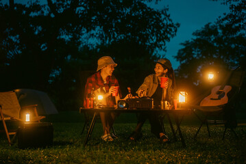Cheers! Group of asian people friend party camping in nature making toasting with soft drink and beer red cup. Hangout party outdoor in campsite nature forest background on holiday weekend vacation