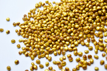gold masterbatch granules on a white background, this polymer is a coloring agent for products in the plastics industry