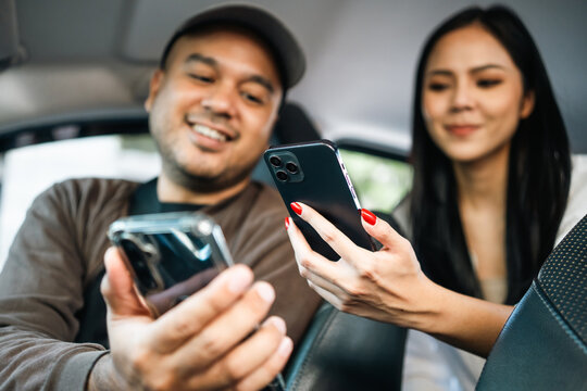 Young asian woman traveler Pay the fare after arriving destination by scan payment qr code with cell phone. Taxi driver finish the job Drop off passengers. Application driver service