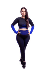 Fototapeta premium A woman with a beautiful figure in black sportswear. Smiling brunette with long hair. Health, sports and active lifestyle. Isolated on a white background. Full height. Vertical.