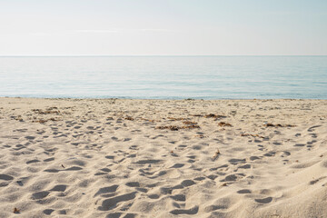 Fototapeta na wymiar Seascape. Blue sea and white sand. Calm and relaxation background.