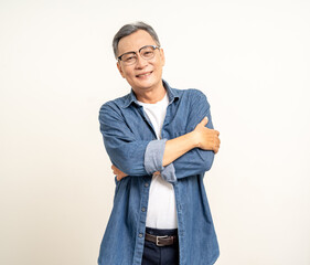 Handsome asian mature old man standing arm crossed on isolated white background. Happy Portrait of cheerful smiling senior asian man looking at camera. Mature People and lifestyle