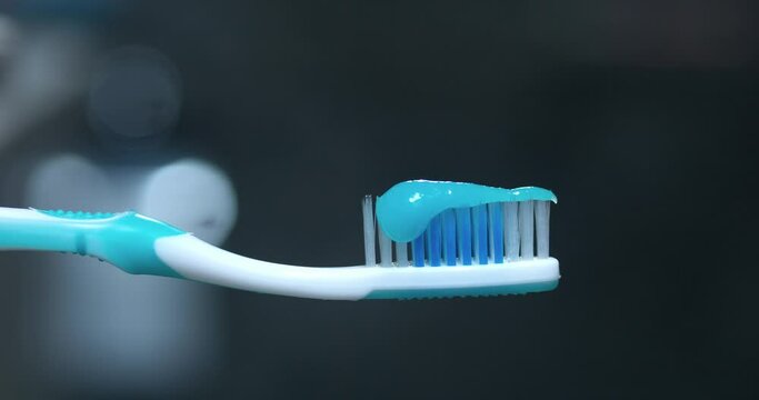 Toothpaste squeezed onto toothbrush close-up marks start of dental cleaning ritual Toothpaste key for oral care ensuring teeth gum health. Daily use of toothpaste promotes hygiene self-respect.