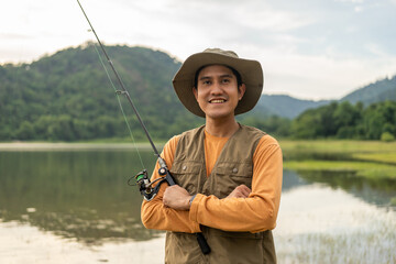 Enjoy moment of Handsome man fishing as a leisure activity during his vacation at the lake on...